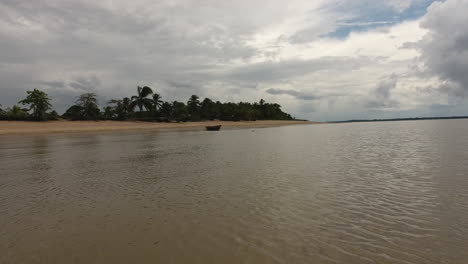 Aerial-oversea-flight-towards-a-canoe-on-a-beach-Awala-Yalimapo-village-Guiana